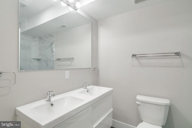 full bath featuring toilet, a sink, and visible vents