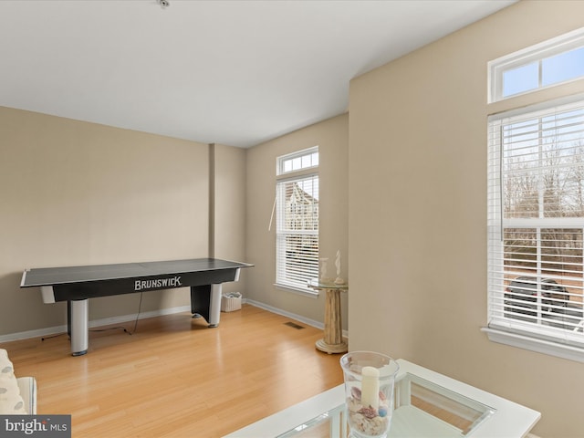 interior space featuring wood finished floors, visible vents, and baseboards