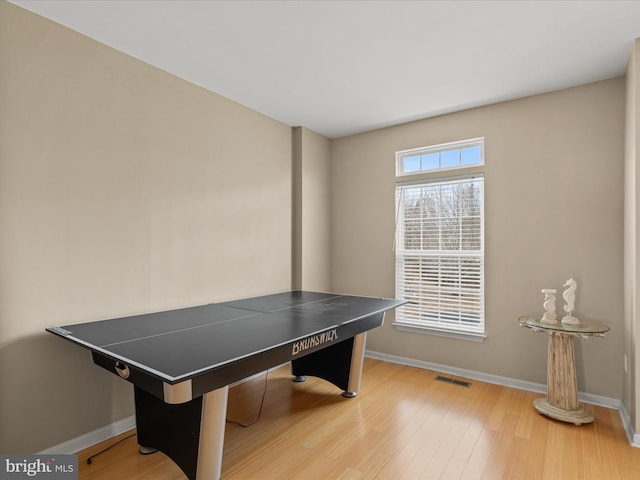 playroom with wood finished floors, visible vents, and baseboards