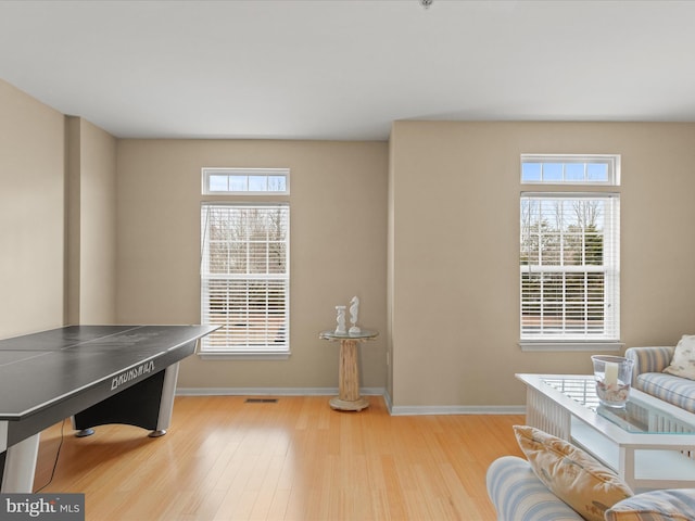 interior space with visible vents, baseboards, and wood finished floors