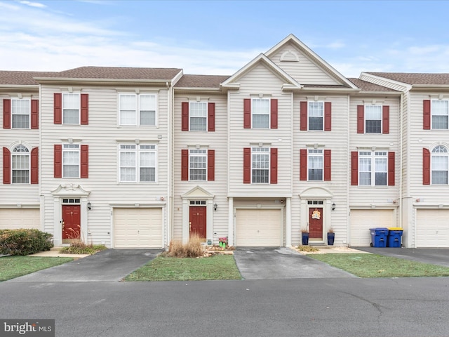 townhome / multi-family property with driveway and a garage