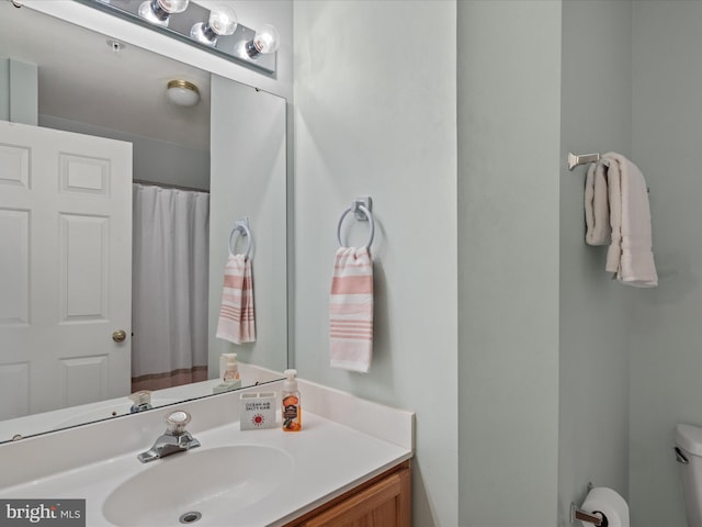 bathroom with toilet and vanity