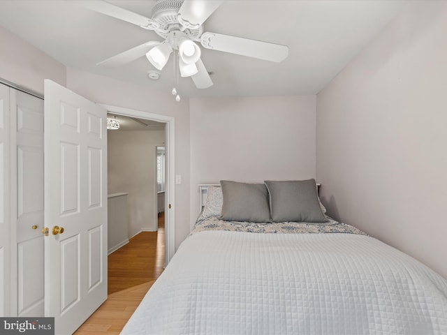 bedroom with light wood-style floors and a ceiling fan