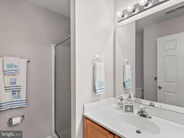 full bath with a stall shower, visible vents, and vanity