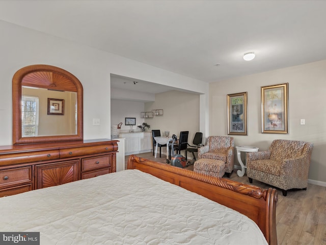 bedroom featuring baseboards and wood finished floors