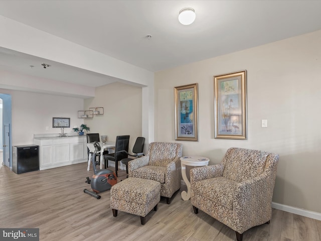 living area featuring light wood-style flooring and baseboards