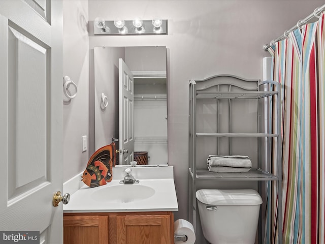 bathroom with toilet and vanity