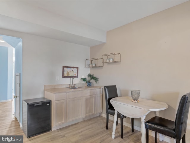 dining area featuring light wood-type flooring and baseboards