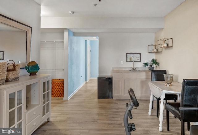 interior space featuring light wood-style flooring and baseboards