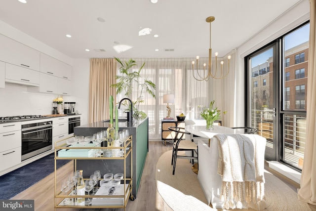 1500 Harry Thomas Way NE Unit 501, Washington, DC 20002 - kitchen featuring a sink, appliances with stainless steel finishes, light wood-style floors, white cabinetry, and modern cabinets