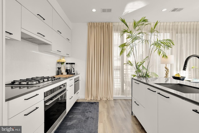 1500 Harry Thomas Way NE Unit 501, Washington, DC 20002 - kitchen with visible vents, white cabinets, stainless steel appliances, and a sink