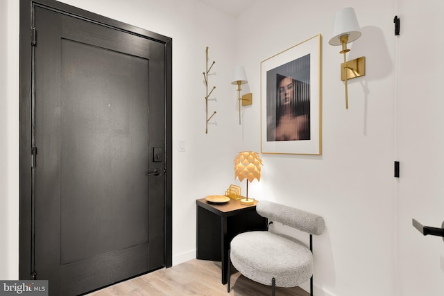 entrance foyer with baseboards and light wood-style floors