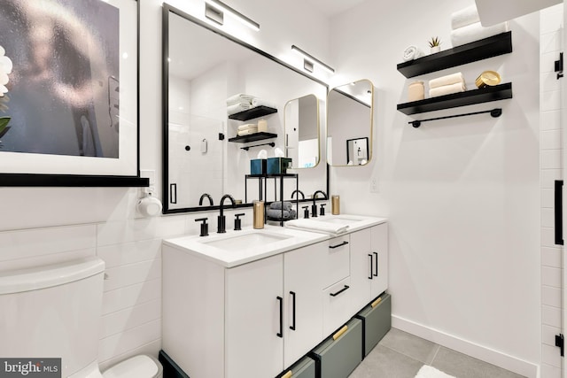 1500 Harry Thomas Way NE Unit 501, Washington, DC 20002 - bathroom featuring tile patterned flooring, toilet, a tile shower, and a sink