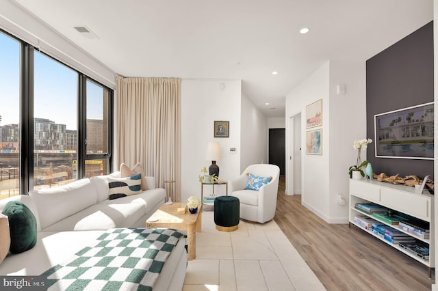1500 Harry Thomas Way NE Unit 501, Washington, DC 20002 - living area featuring baseboards, visible vents, recessed lighting, a city view, and light wood-type flooring