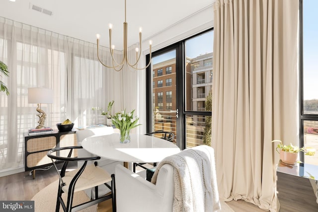 1500 Harry Thomas Way NE Unit 501, Washington, DC 20002 - dining area featuring a chandelier, plenty of natural light, visible vents, and wood finished floors
