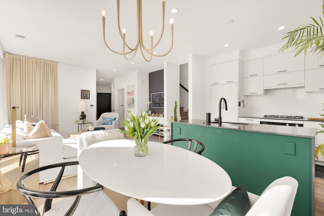 1500 Harry Thomas Way NE Unit 501, Washington, DC 20002 - dining area with visible vents, a notable chandelier, recessed lighting, stairway, and light wood-style floors