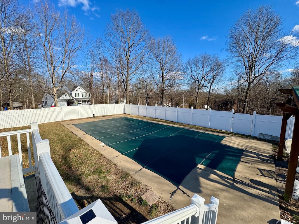 view of swimming pool with a fenced backyard and a fenced in pool