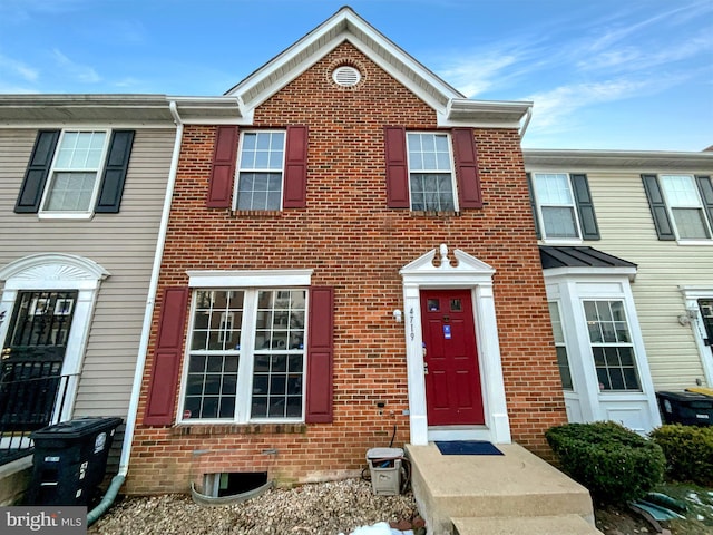 view of property featuring brick siding