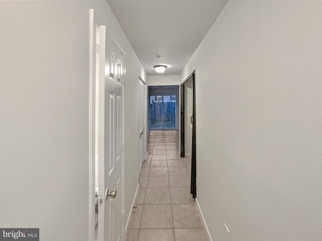 hall with light tile patterned floors and baseboards