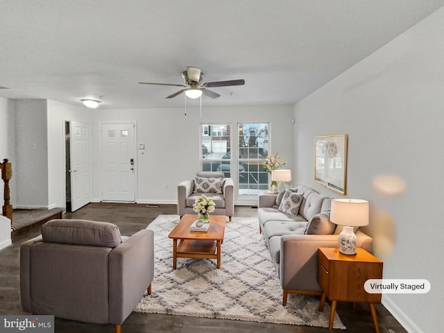 living room with wood finished floors, a ceiling fan, and baseboards