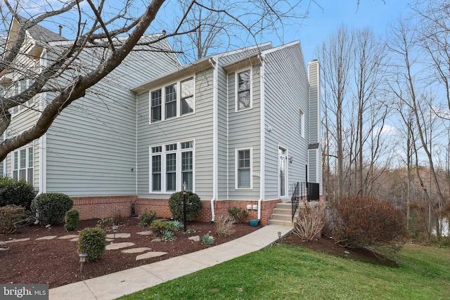 view of front of property featuring a front lawn and a chimney