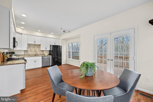 dining area featuring visible vents, baseboards, recessed lighting, french doors, and wood finished floors