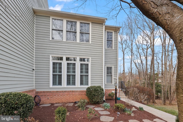 view of side of home featuring brick siding