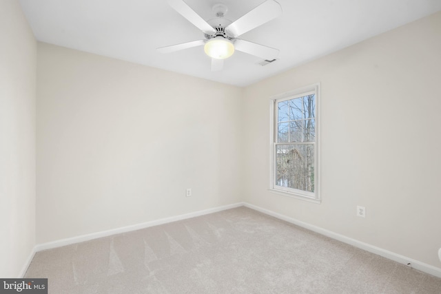 unfurnished room featuring baseboards, carpet floors, and ceiling fan