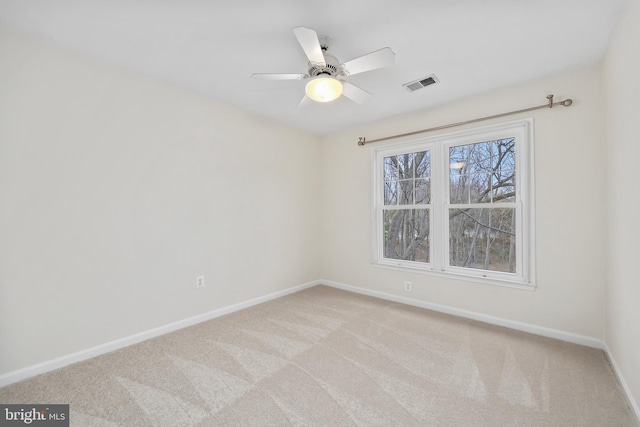 unfurnished room with carpet flooring, baseboards, visible vents, and ceiling fan