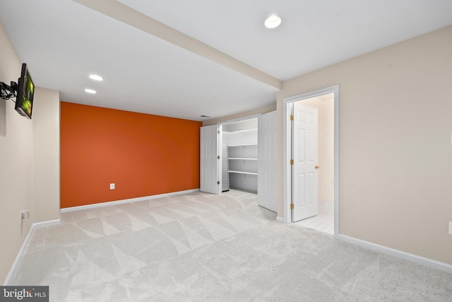 interior space featuring recessed lighting, baseboards, and light colored carpet