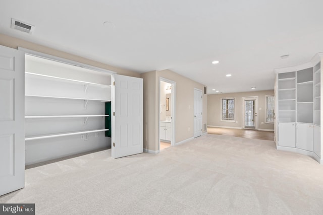 interior space featuring recessed lighting, visible vents, carpet flooring, and baseboards