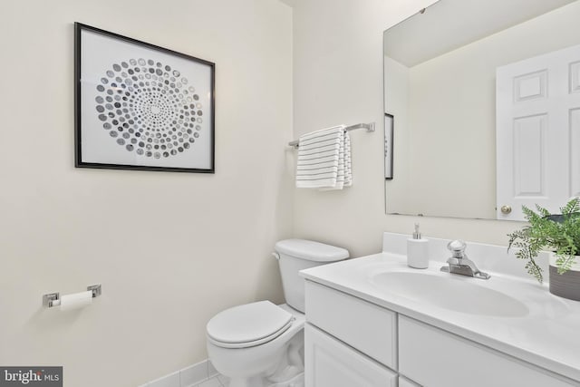 half bathroom with toilet and vanity