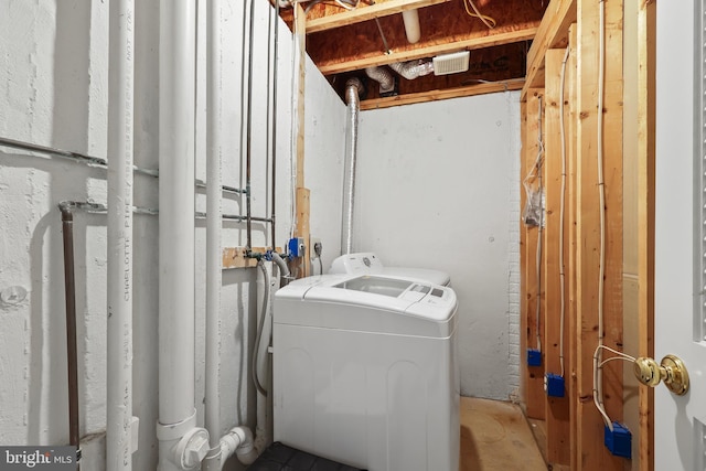 washroom with washing machine and dryer and laundry area