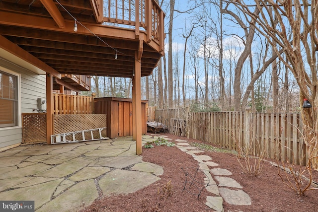 view of yard with a patio area, an outbuilding, and a fenced backyard