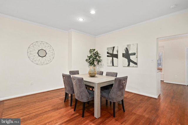 dining space with crown molding, baseboards, and dark wood-style flooring