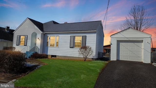 view of front of home featuring an outbuilding, a garage, driveway, a lawn, and roof with shingles