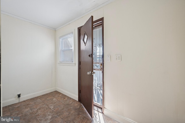 entryway featuring crown molding and baseboards