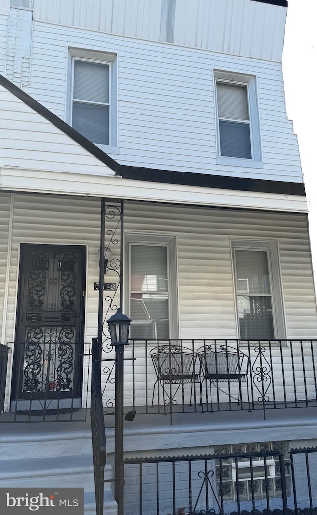 view of exterior entry with covered porch