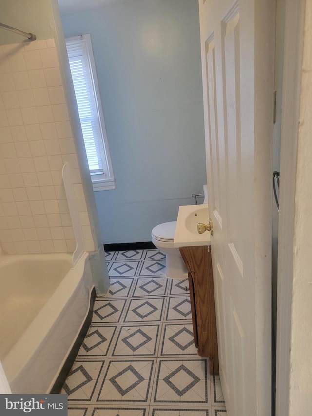 full bath featuring tile patterned flooring, toilet, vanity, and bathtub / shower combination