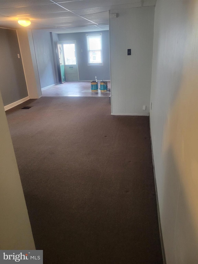 carpeted empty room featuring visible vents