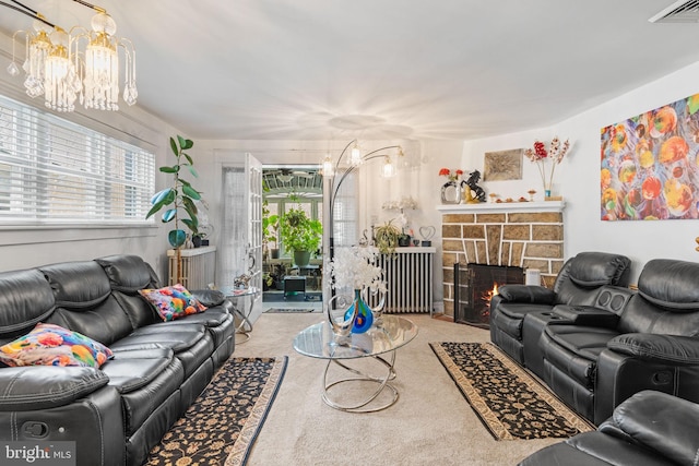 living area with visible vents, a fireplace, a chandelier, and carpet flooring