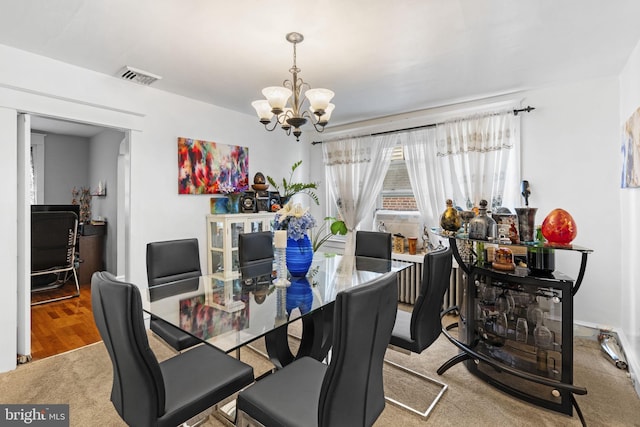 carpeted dining space with visible vents and a chandelier