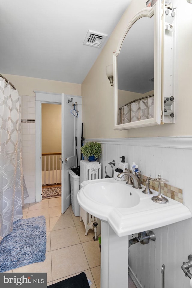 full bathroom with visible vents, a wainscoted wall, and tile patterned flooring