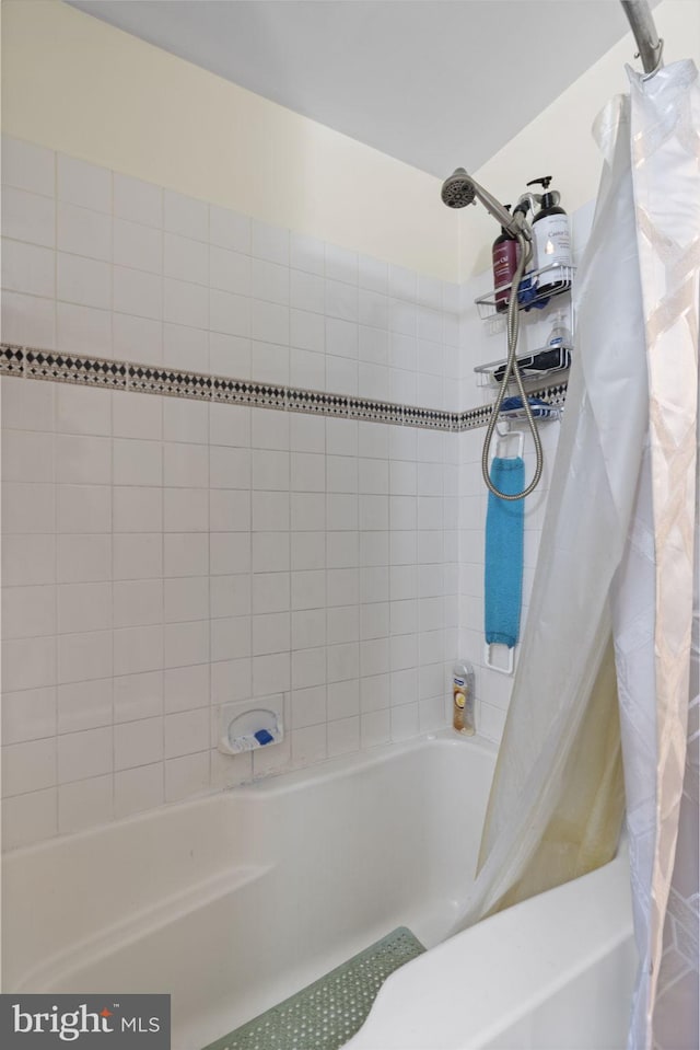 bathroom with shower / tub combo with curtain