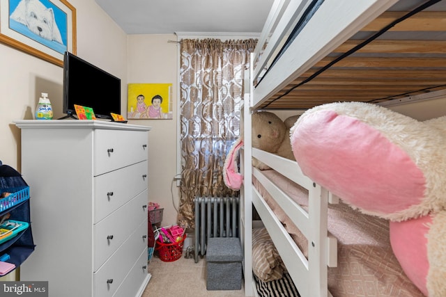 carpeted bedroom with radiator heating unit