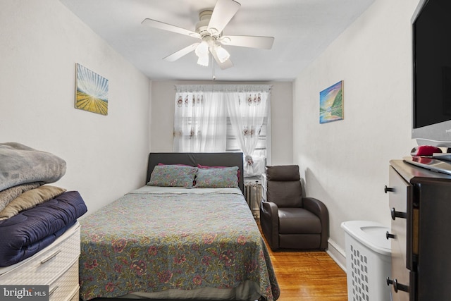 bedroom with a ceiling fan and wood finished floors