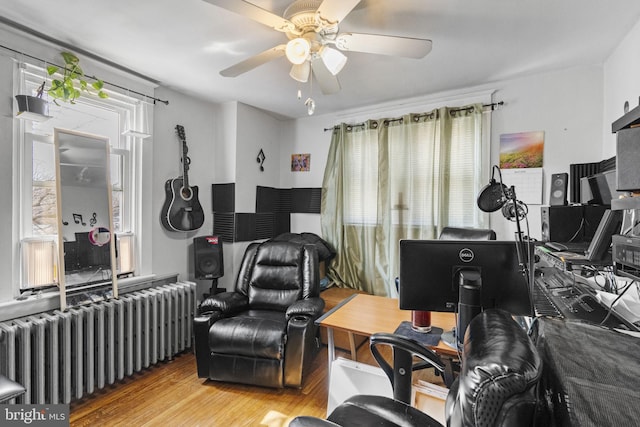 interior space featuring wood finished floors, radiator, and ceiling fan