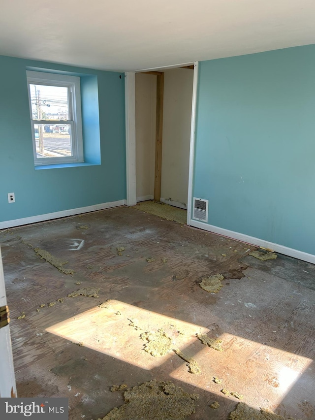 spare room featuring baseboards and visible vents