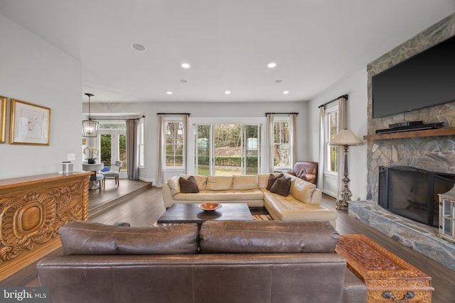 living room featuring recessed lighting, wood finished floors, and a fireplace