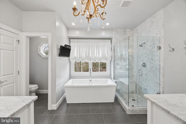 full bathroom with visible vents, toilet, a shower stall, baseboards, and a freestanding bath